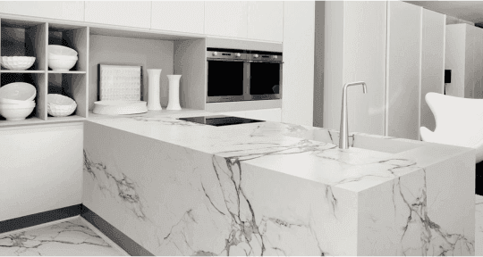 Muebles de cocina con mesadas de porcelanato y alacenas. 